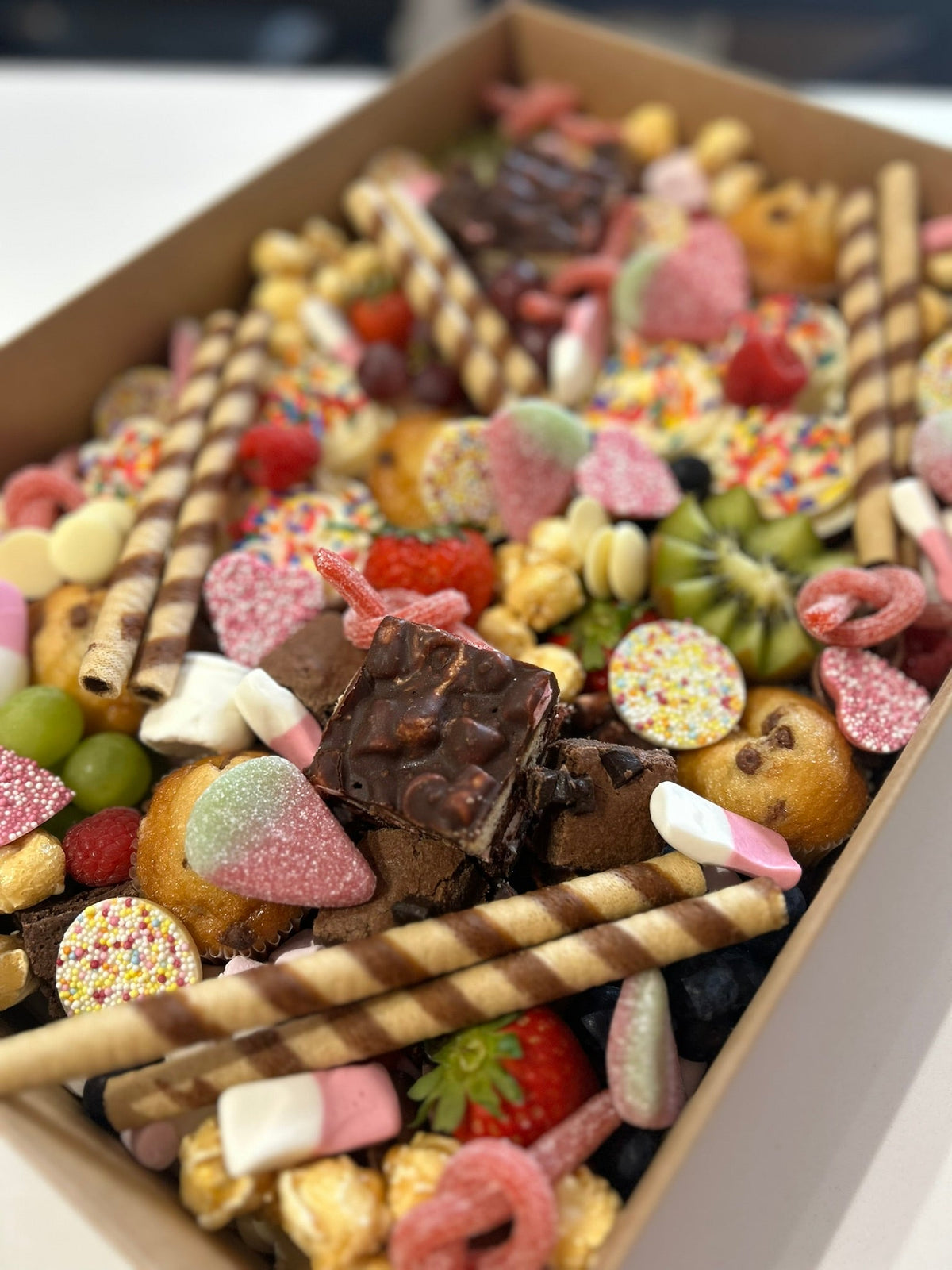 Sweet grazeable box with fruits, cakes, sweets and wafers 