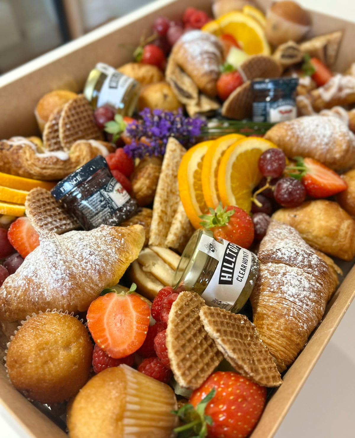 Assorted pastries, fruits in a brunch grazeable box