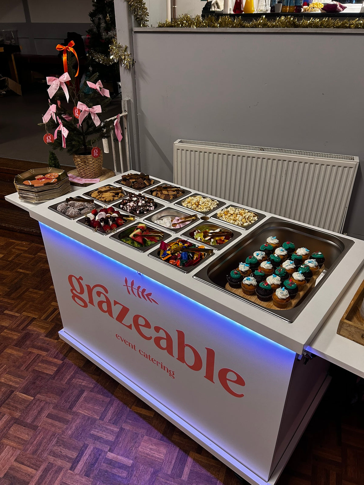 Grazeable event dessert bar with various  sweet food items displayed with Christmas decorations